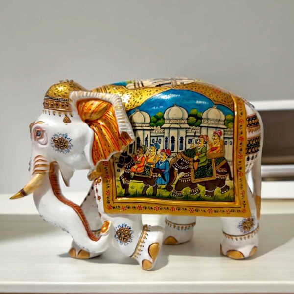 White wood elephant statue miniature painted on right side of elephant