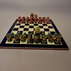 wooden hand painted chess pieces red green color on chess board