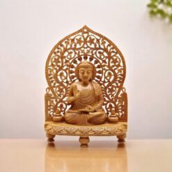 Wooden Buddha statue sitting on carved wood stand in meditation pose