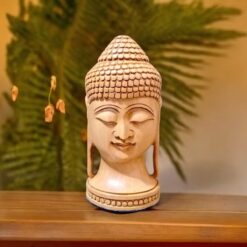 Wooden Buddha face placed on a wood table