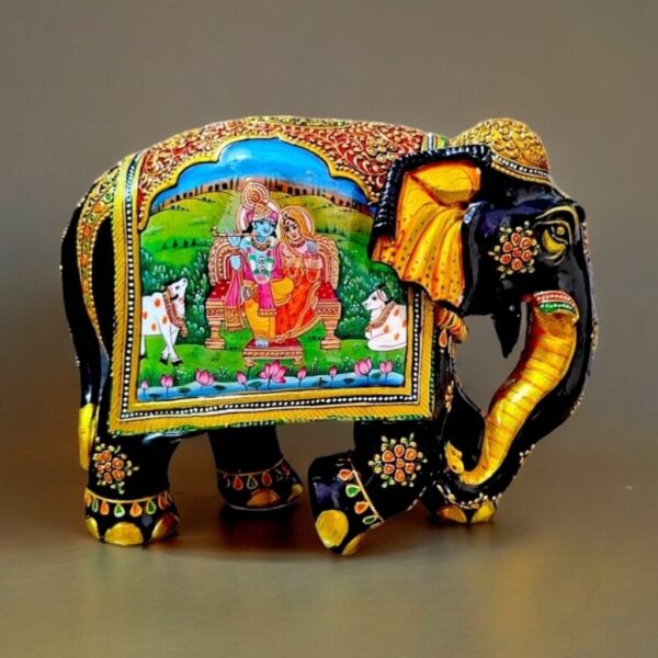 wooden elephant painted with Radha Krishna figurines miniature painting on it