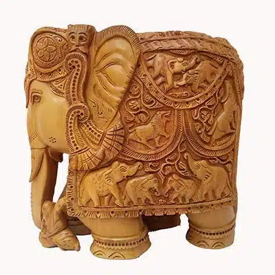 Hand-carved Indian wooden elephant sculpture with intricate patterns and cultural craftsmanship.