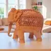 elephant figurine with intricate carvings, cultural motifs, and natural earthy tones.