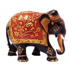 Wooden hand painted elephant figurine with red floral saddle and gold details.