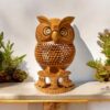 Handcrafted wooden owl statue a jalee work on it and two small owl also setting under it