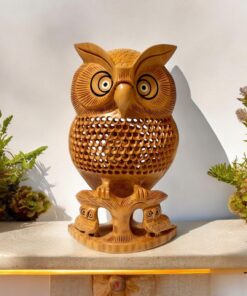 Handcrafted wooden owl statue a jalee work on it and two small owl also setting under it