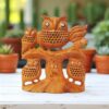 Wooden owl family sculpture with intricate craftsmanship and natural tree trunk design.