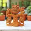 Wooden owl family sculpture with intricate craftsmanship and natural tree trunk design.