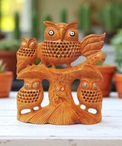 Wooden owl family sculpture with intricate craftsmanship and natural tree trunk design.