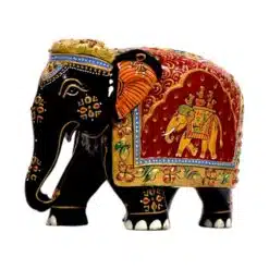 Decorative Indian elephant figurine with black body, colorful patterns, and ornate saddle.