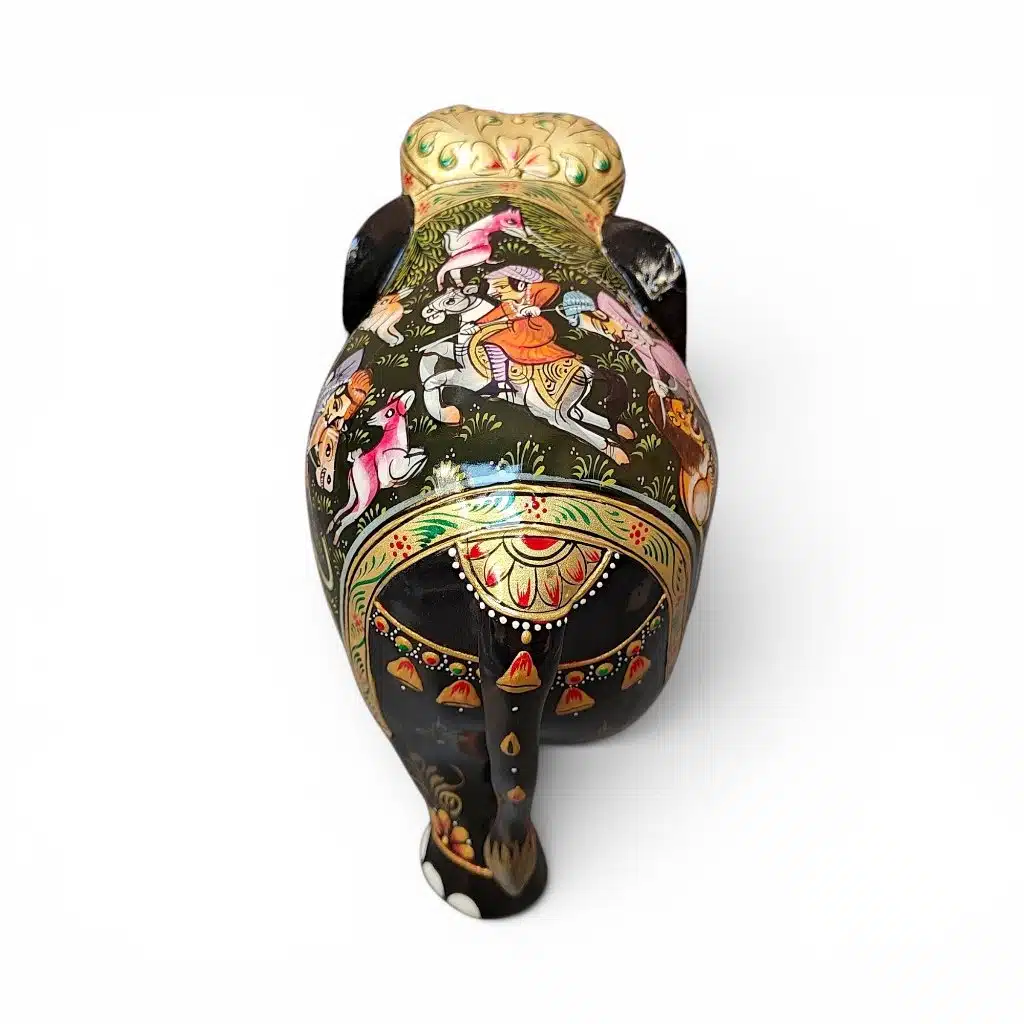 Little wooden elephant statue with colorful hand-painted Indian folk art designs.