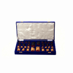 Hand carved wooden chess set displayed inside an open blue velvet case.