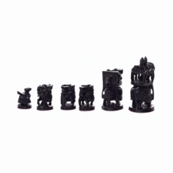Intricate dark pieces of a hand carved wooden chess set on a white background.
