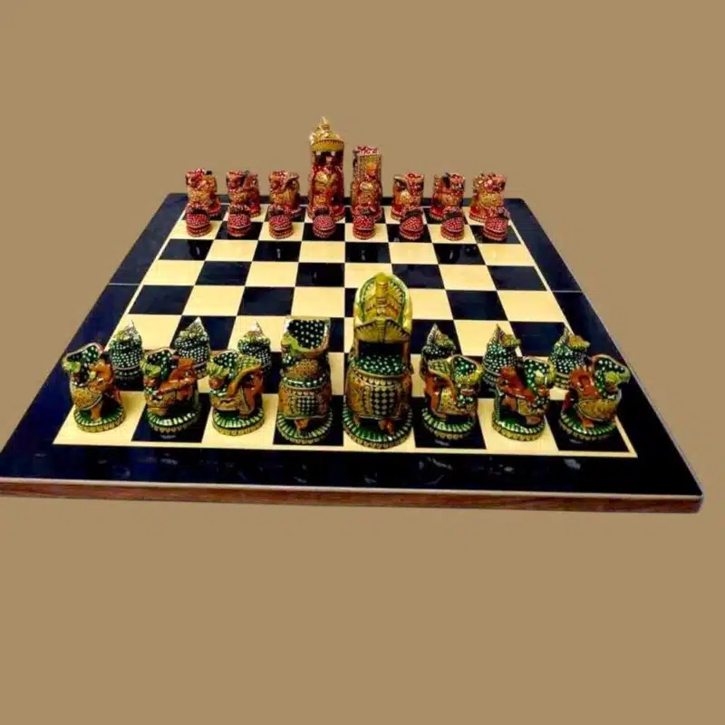 Wooden chess set on a chess board, Maharajah style chess in green and red color theme