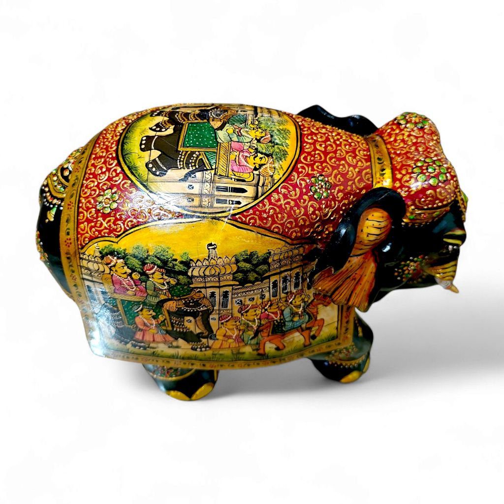 Traditional Indian handcrafted decorative elephant with vibrant colors, intricate patterns, royal scenes, and gold accents.