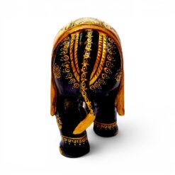 Carved wooden elephant figurine with glossy black finish and gold decorative patterns.