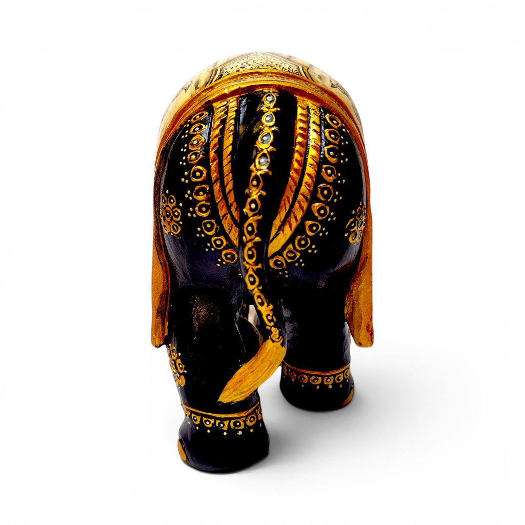 Carved wooden elephant figurine with glossy black finish and gold decorative patterns.
