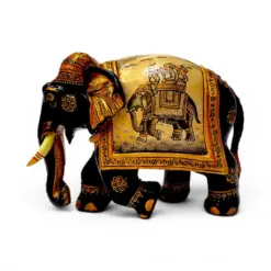 Carved wooden elephant figurine with ornate Indian gold and black painted details.