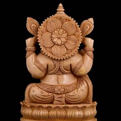 Intricately carved wooden Ganesha statue back view with lotus pedestal and halo.