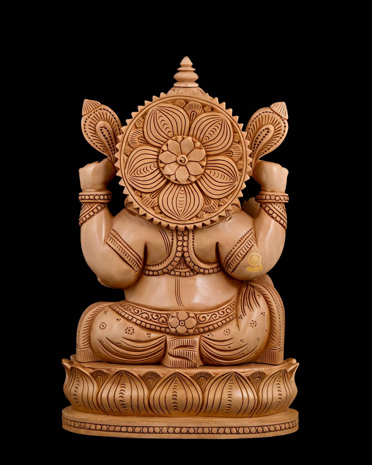 Intricately carved wooden Ganesha statue back view with lotus pedestal and halo.