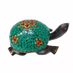 Colorful mosaic turtle sculpture with gold floral accents, wooden body, and vibrant decorative design.