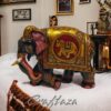 Decorative black elephant figurine with colorful ornate blanket, symbolizing prosperity and cultural artistry.