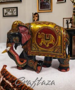 Decorative black elephant figurine with colorful ornate blanket, symbolizing prosperity and cultural artistry.