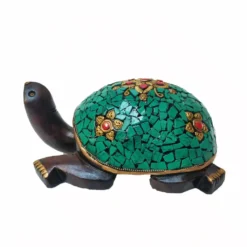 Decorative wooden turtle sculpture with turquoise mosaic shell and gold floral accents for good luck.