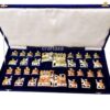 handcrafted chess set in deep blue velvet case with intricate, culturally themed pieces.