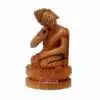 Hand-carved wooden Buddha statue with lotus symbolizing peace and spiritual enlightenment.
