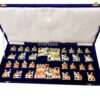 handcrafted chess set in deep blue velvet case with intricate, culturally themed pieces.