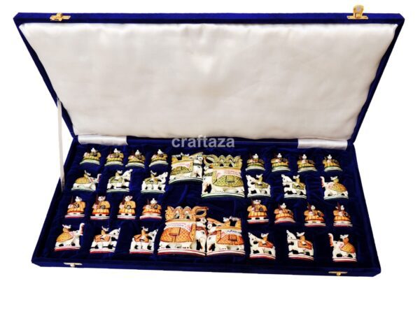 handcrafted chess set in deep blue velvet case with intricate, culturally themed pieces.