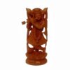 Wooden Krishna statue playing flute with ornate attire and intricate carvings.