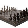 Elegant bronze chess set on ornate board, perfect for art, decor, and strategic gameplay.