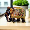 Indian decorative elephant figurine with intricate floral patterns and festive procession scene.