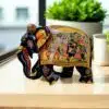 Indian decorative elephant figurine with intricate floral patterns and festive procession scene.