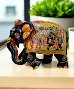 Indian decorative elephant figurine with intricate floral patterns and festive procession scene.