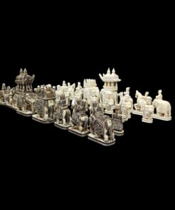 Ivory chess set with detailed, mythological figures and architectural structures on a black background.