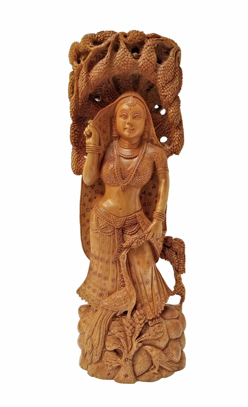 Intricately carved wooden sculpture of a regal mythological female figure with detailed jewelry and natural elements.