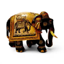 Ornate carved wooden elephant figurine with colorful Indian ceremonial painted details.