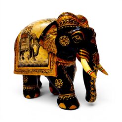 Carved wooden elephant figurine with ornate gold and red Indian-style painted details.