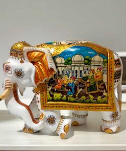 White wood elephant statue miniature painted on right side of elephant