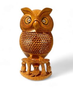 Hand-carved wooden owl sculpture with intricate feather details and woodland foliage base for home decor.