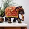 Colorful Indian elephant figurine with gold accents, floral motifs, and raised trunk for good luck.