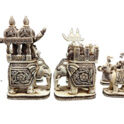 Intricate ivory elephant figurines with regal palanquin and traditional carvings