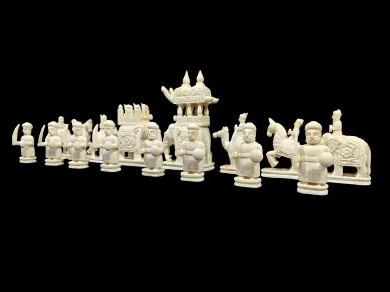 Intricately carved Asiancamel bone chess set with ceremonial figures, knights, warriors,
