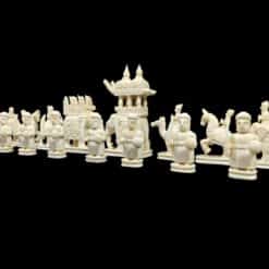 Intricately carved Asiancamel bone chess set with ceremonial figures, knights, warriors,