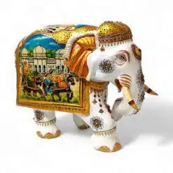 Decorative elephant sculpture with intricate designs and scenic painted saddle.