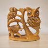 Wooden sculpture of owls, elephant, and tree emphasizing wildlife art and nature-inspired decor.