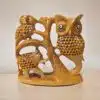 Wooden sculpture of owls, elephant, and tree emphasizing wildlife art and nature-inspired decor.